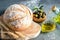 Loaf of white bread and some wheat ears on the wooden kitchen cutting board. Olives in wooden bowl and olive oil, dark background