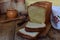 A loaf of white bread on a wooden background. Homemade Yeast Baking