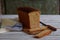 A loaf of white whole grain bread on a wooden background. Homemade Yeast Baking