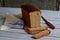 A loaf of white whole grain bread on a wooden background. Homemade Yeast Baking