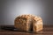 Loaf of wholemeal bread with knife on table