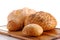 Loafs of bread and rolls on breadboard