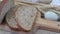 Loafs of bread, slices of bread, wheat flour, eggs and ears of grain on wood background. Rustic and rural concept. Close