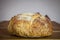 Loafs or miche of French sourdough, called as well as Pain de campagne, on display on a wooden table.