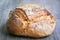 Loafs or miche of French sourdough, called as well as Pain de campagne, on display on a wooden table.