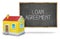 Loan agreement text on blackboard with 3d house