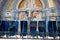 Loans of blue wheelchairs in front of the church within the Sanctuary in Lourdes