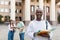 Loans for education concept. Portrait of african american male student posing near university building