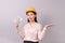 Loans for real estate concept, woman with yellow helmet holding banknote money in right hand and open the empty palm