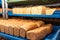 Loaves of bread on blue plastic trays