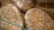 Loaves of rye farm bread lie on the wooden bakery shelf. Close-up shot. Shopping at the grocery store. Selling food