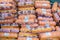 Loaves of sausage and lie side by side in a basket in a large store for sale.