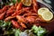A lobster on a big Golden platter.Scatter the lemon and the Bay leaf. Restaurant food. A lobster on a silver metal plate