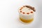 Lobster bisque soup with a creamy foam topping and linen seed garnish in a glass on a light gray table, copy space, selected focus