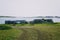 Lobster fishing cages on green grass with sea and island. Brittany France