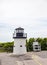 Lobster point lighthouse along the rocky coast of Maine on the Marginal Way path in Ogunquit