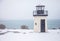 Lobster point lighthouse along the rocky coast of Maine on the Marginal Way path in Ogunquit during winter