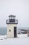 Lobster point lighthouse along the rocky coast of Maine on the Marginal Way path in Ogunquit during winter