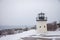 Lobster point lighthouse along the rocky coast of Maine on the Marginal Way path in Ogunquit during winter