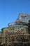 Lobster pots stacked up against blue sky