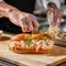 Lobster roll. Chef cooking classic New England seafood sandwich. Lobster with lemon juice, mayo, butter, celery, scallion