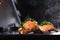 Lobster tails on an open grill. Cooking a dish of langoustes. Dark background. Close up