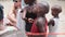 Local African Hungry Child Eats Paper on Street among People, Zanzibar, Africa