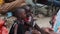 Local African Hungry Child Eats Paper on Street among People, Zanzibar, Africa