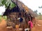 Local African village in summertime, clay houses and thatched roofs, banana trees. Travel and tourism concept