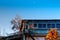 Local blue Japanese house with colourful autumn persimmon tree with fruits against blue clear sky