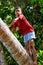 Local boy climbing palm tree in Lavena village, Taveuni Island,
