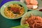 Local breakfast: fried bee hoon, noodle soup, and fried snacks on table