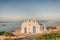 Local church in Pirgaki in Paros island against the blue Aegean sea. A beautiful landscape.
