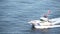 Local coastguard on a motorboat is waving good bye to passenger on a cruise ship