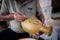 Local craftsman demonstrates on making traditional clay jar called