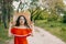 Local Domestic travel, green tourism . Summer time concept. Portrait of a beautiful woman in straw hat and red dress