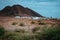 Local dwelling in front of Calhau volcanic crater, Cape Verde - Sao Vicente Island. Single martian like dry red rock