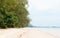 Local empty beach in sunny day, photo divided in three sections, tree, sky and sea, very bright day