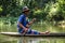 Local farmer paddling his traditional pirogue outside the sadan cave, Hpa-an, Hpa-an District, Myanmar