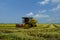 Local farmer uses machine to harvest rice on paddy field