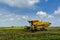 Local farmer uses machine to harvest rice on paddy field.