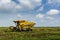 Local farmer uses machine to harvest rice on paddy field.