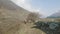 Local farmers carry heavy wicker baskets on the heads in Nepal. Manaslu area.