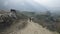 Local farmers carry heavy wicker baskets on the heads in Nepal. Manaslu area.