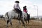 Local farmers riding their quaterhorses, competing at a cutting horse, futurity