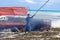 Local fisherman burning boat to get rid of seaweed