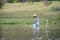 Local fisherman casts his nets in the shallow waters of Lake Naivasha