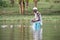 Local fisherman casts his nets in the shallow waters of Lake Naivasha