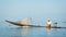 Local fisherman floats on fishing boat with a motor. Inle lake, Burma (Myanmar)