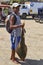 A Local Fisherman with a recently caught Angel Shark carrying it Home in the Fishing Village of Mancora.